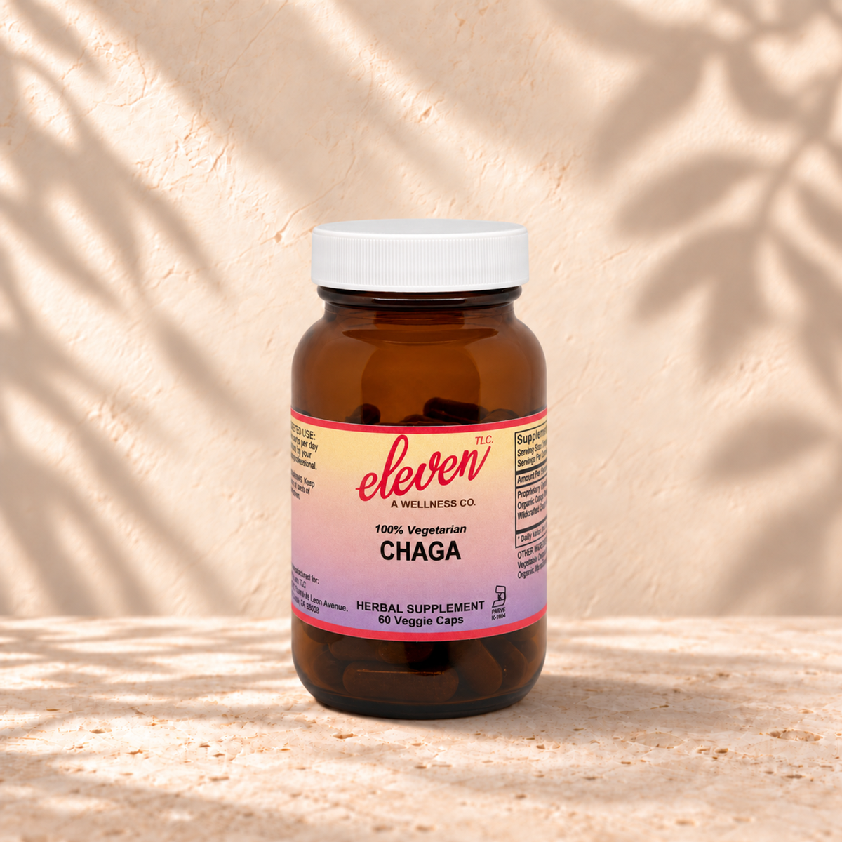 Eleven TLC organic Chaga mushroom capsules for immune support, 60-count amber glass bottle with pink and yellow label