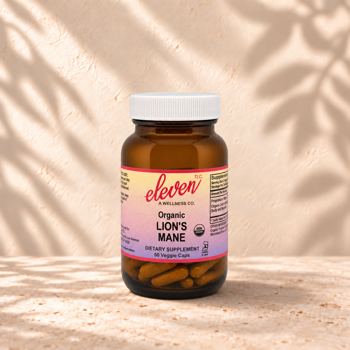 Eleven TLC Lion's Mane mushroom capsules for focus and clarity, 60-count amber glass bottle with pink and yellow label