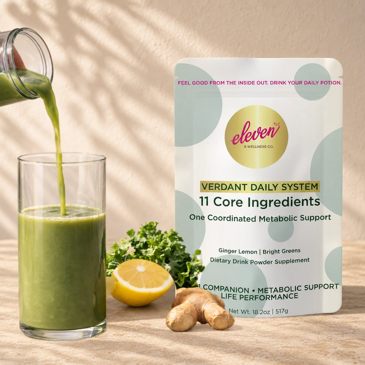 Eleven TLC Verdant Daily System ginger lemon greens drink powder pouch beside a green smoothie being poured, with kale, lemon and fresh ginger