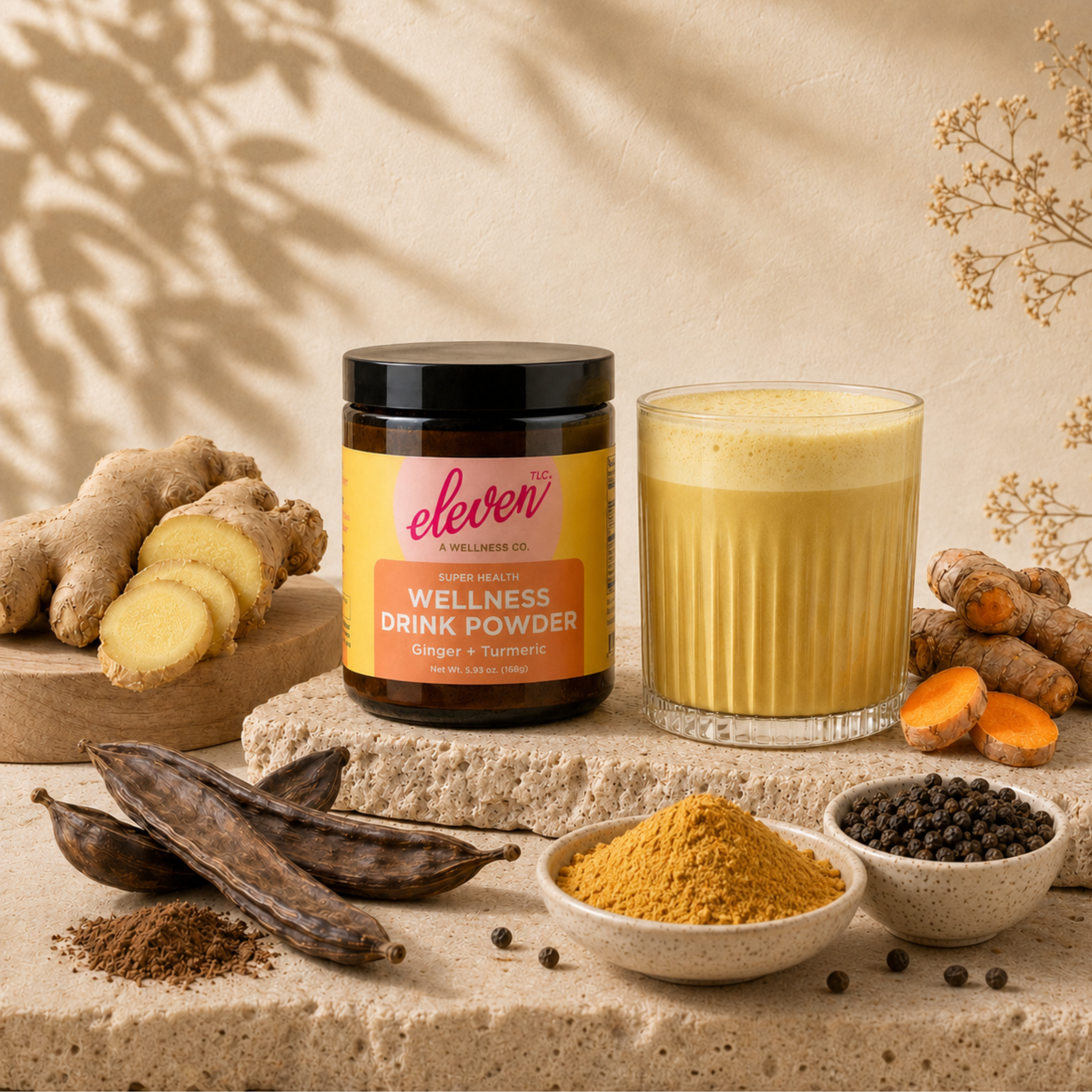 Eleven TLC Organic Ginger Turmeric Drink Mix jar and a frothed golden milk latte, surrounded by its raw whole-food ingredients: ginger root, turmeric, carob pods, and black peppercorns.

Mind