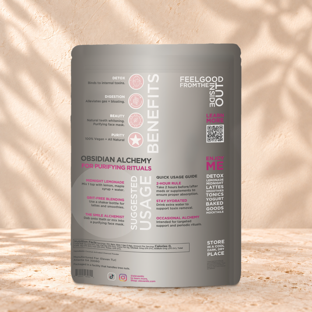 Back panel of the Eleven TLC Activated Coconut Charcoal Powder 500g pouch on a travertine ledge against a warm plaster wall.