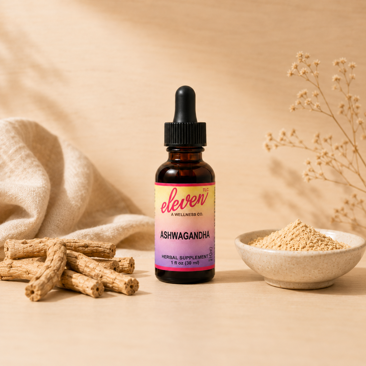 1oz amber glass bottle of Eleven TLC ashwagandha root liquid extract with black dropper, dried roots, and powder bowl.