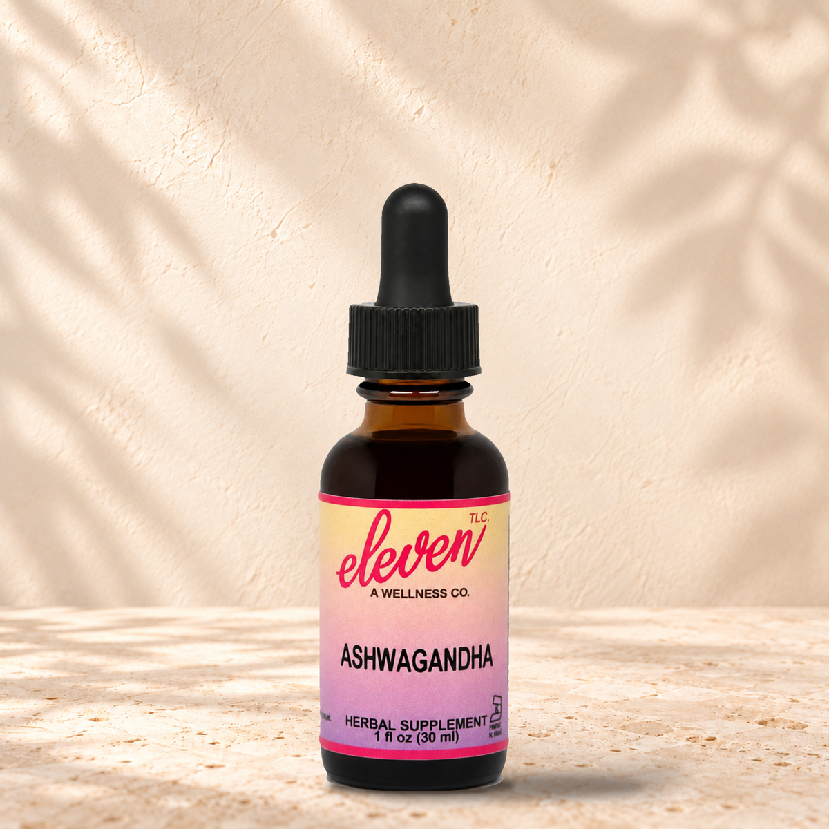 Eleven TLC Ashwagandha root herbal tincture for stress support, 1 fl oz amber dropper bottle with pink and yellow label