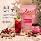 Eleven TLC Bali Rose Tea pouch and 70g jar beside ruby-red hibiscus iced tea with lime and mint and a bowl of loose-leaf tea on warm travertine.