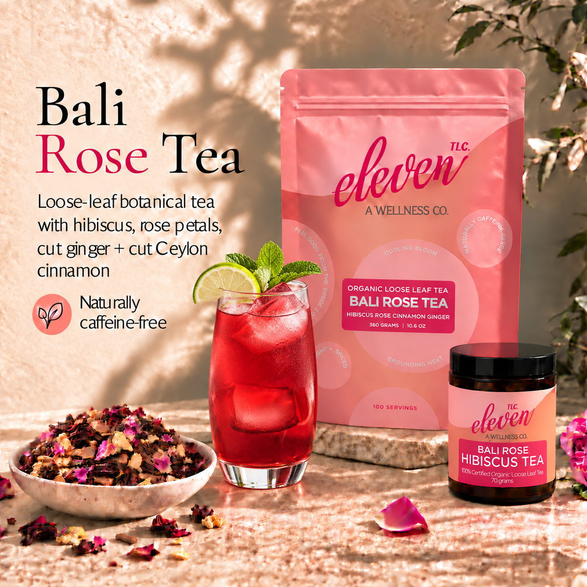 Eleven TLC Bali Rose Tea pouch and 70g jar beside ruby-red hibiscus iced tea with lime and mint and a bowl of loose-leaf tea on warm travertine.