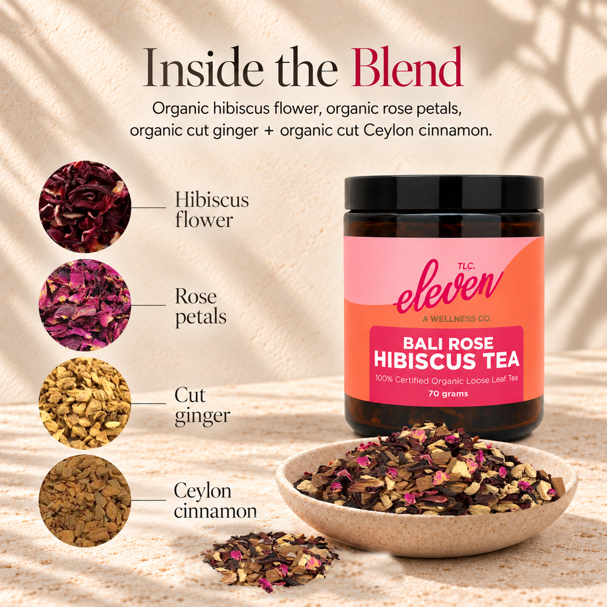 Eleven TLC Bali Rose Hibiscus Tea 70g jar and loose-leaf blend, with close-ups of dried hibiscus, rose petals, golden cut ginger and Ceylon cinnamon on cream travertine.