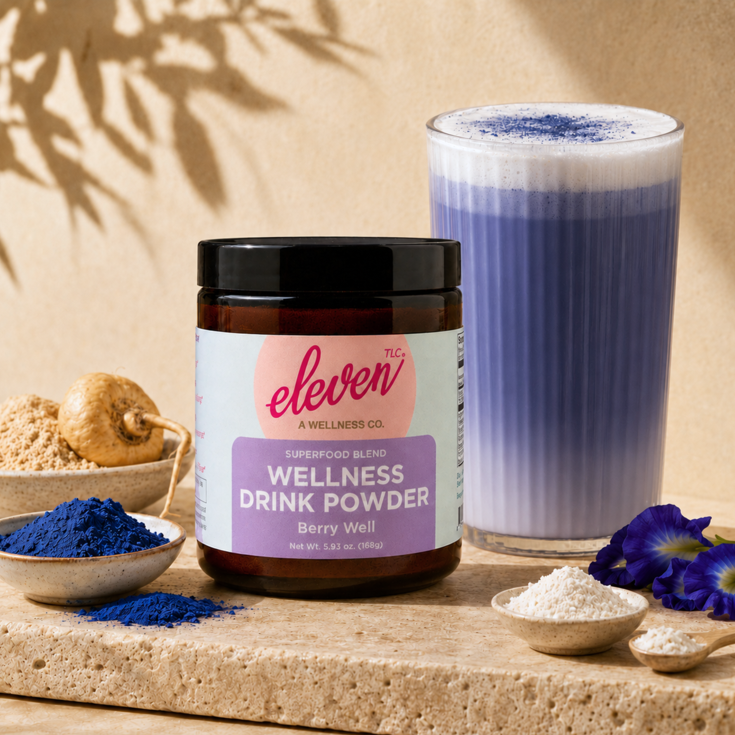 Eleven TLC Berry Well 168g amber glass jar with prepared blue spirulina latte, maca, and butterfly pea flowers.