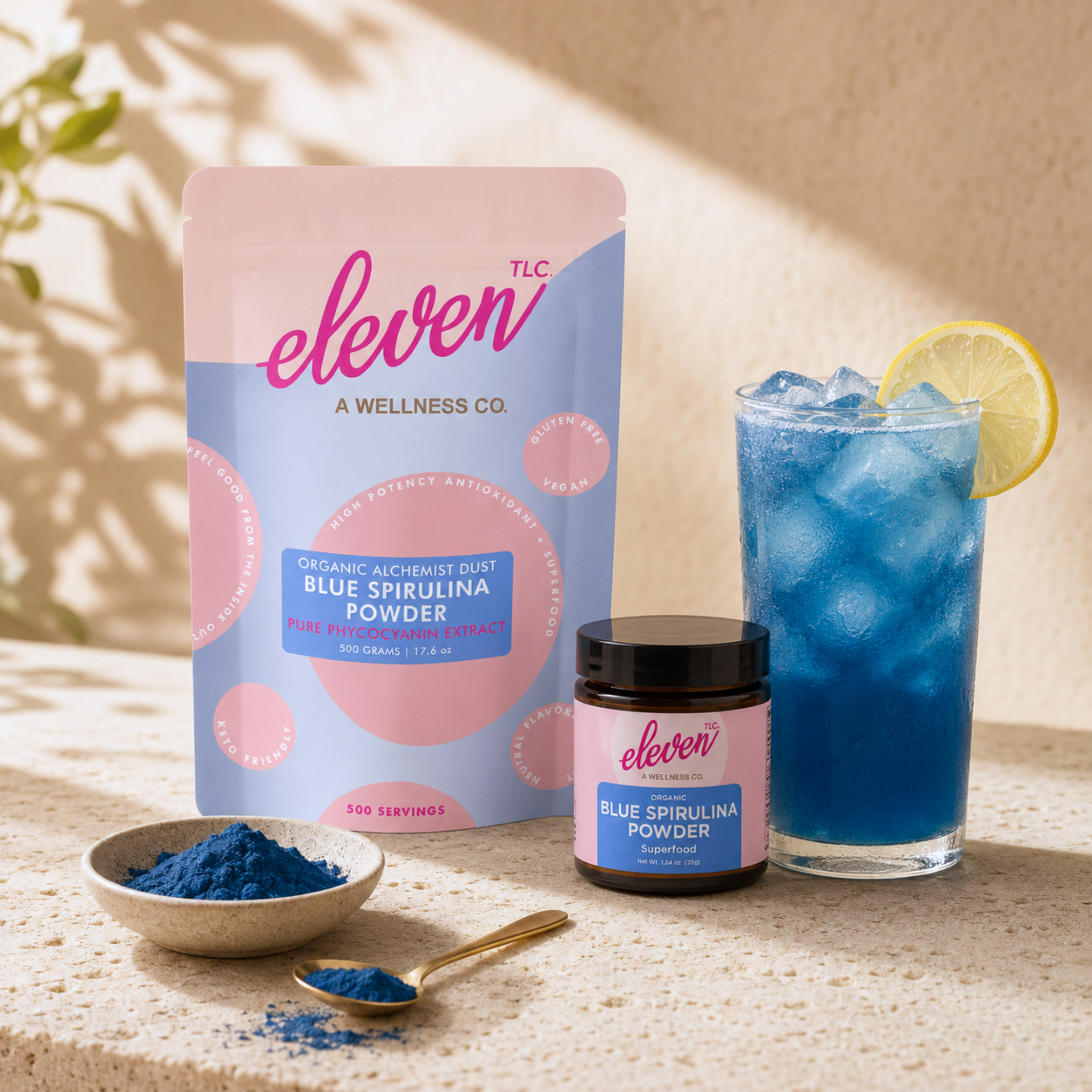 Eleven TLC organic blue spirulina powder in lemonade with lemon slice in glass on marble surface