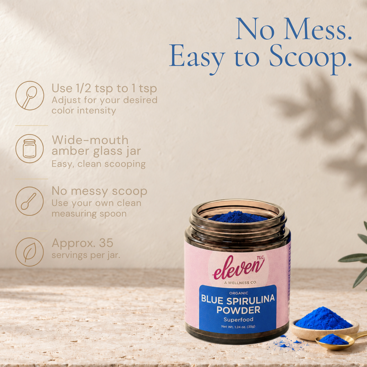 Open wide-mouth jar of Eleven TLC blue spirulina powder with spoons of blue powder and serving guidance.