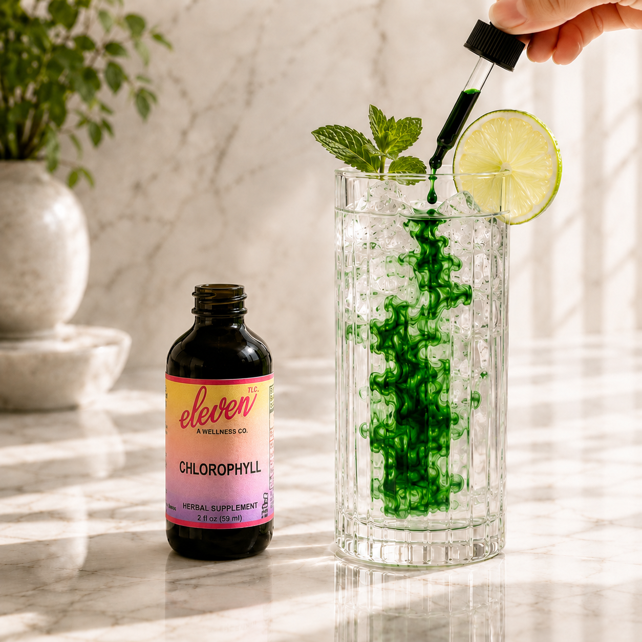 Eleven TLC liquid chlorophyll being added to a highball glass with water, mint, and lime to create a detoxifying chlorophyll water.