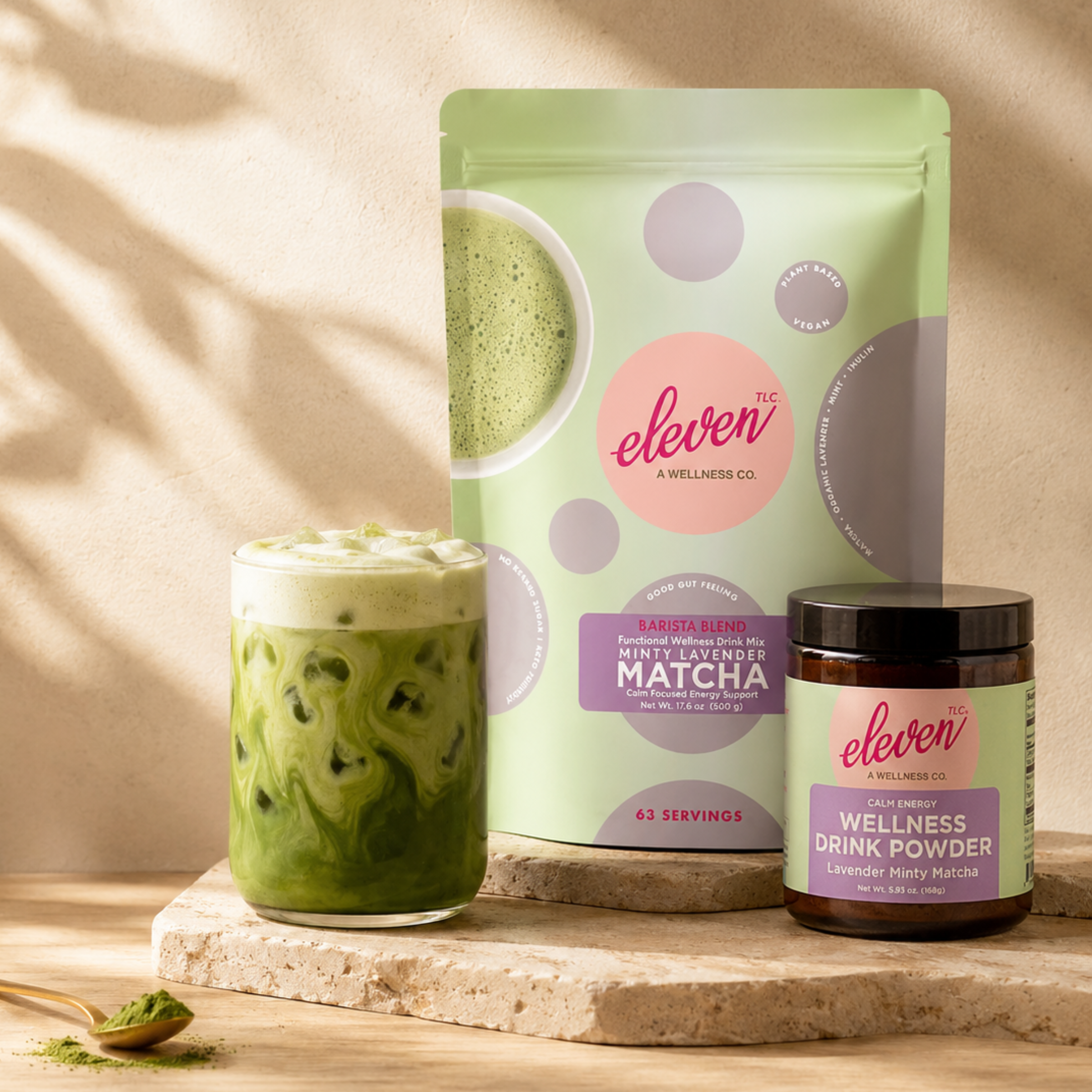 eleven-tlc-minty-lavender-matcha-powder-size-comparison-showing-168g-amber-glass-jar-and-500g-bulk-standing-pouch-on-travertine-stone-for-daily-signal