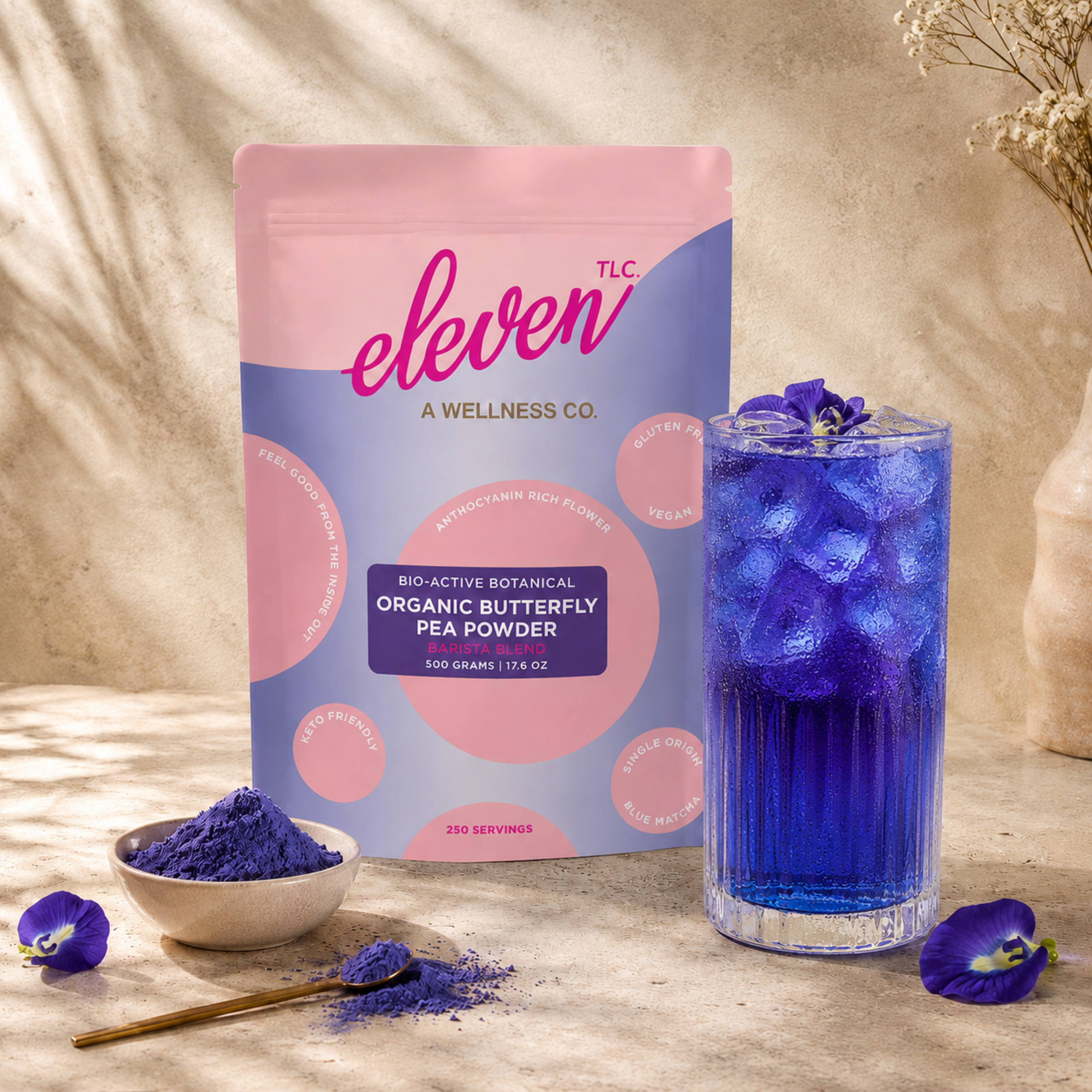 Eleven TLC organic butterfly pea flower powder in branded pouch with prepared blue botanical drink for culinary use