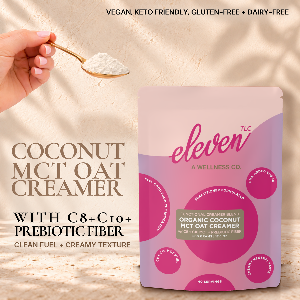 Eleven TLC Organic Coconut MCT Oat Creamer 500g pouch on travertine against a warm cream plaster wall, with a hand holding a gold spoon of creamer powder. Text reads Coconut MCT Oat Creamer with C8 + C10 + prebiotic fiber, clean fuel + creamy texture; vegan, keto friendly, gluten-free + dairy-free.