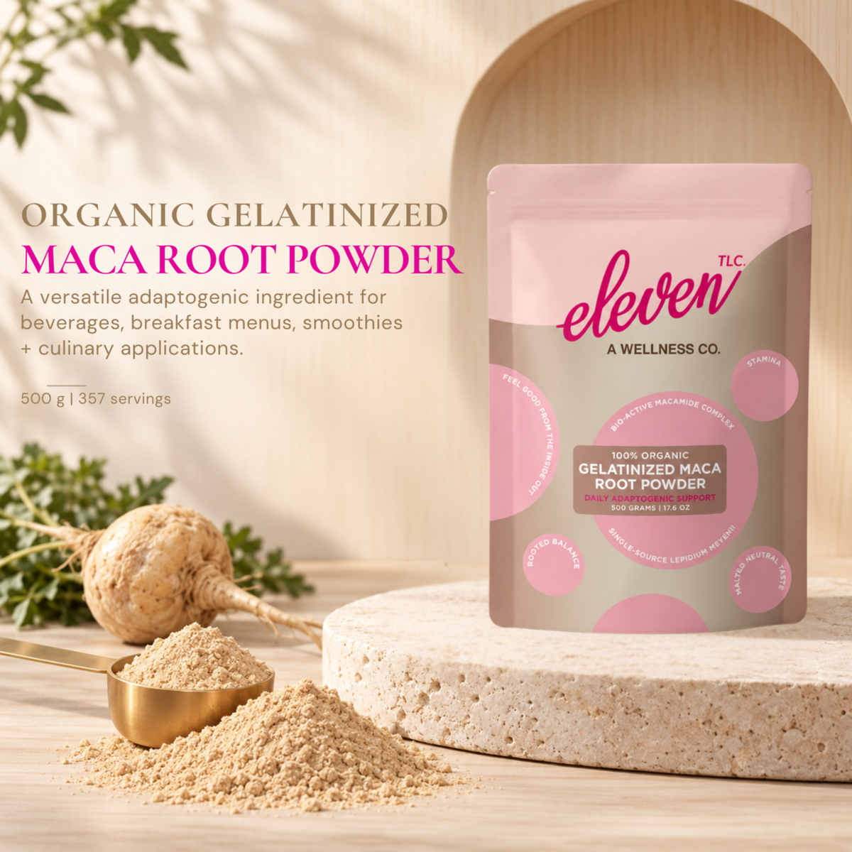 Eleven TLC Organic Gelatinized Maca Root Powder 500 g bag with maca root, powder and a gold measuring cup on warm stone.