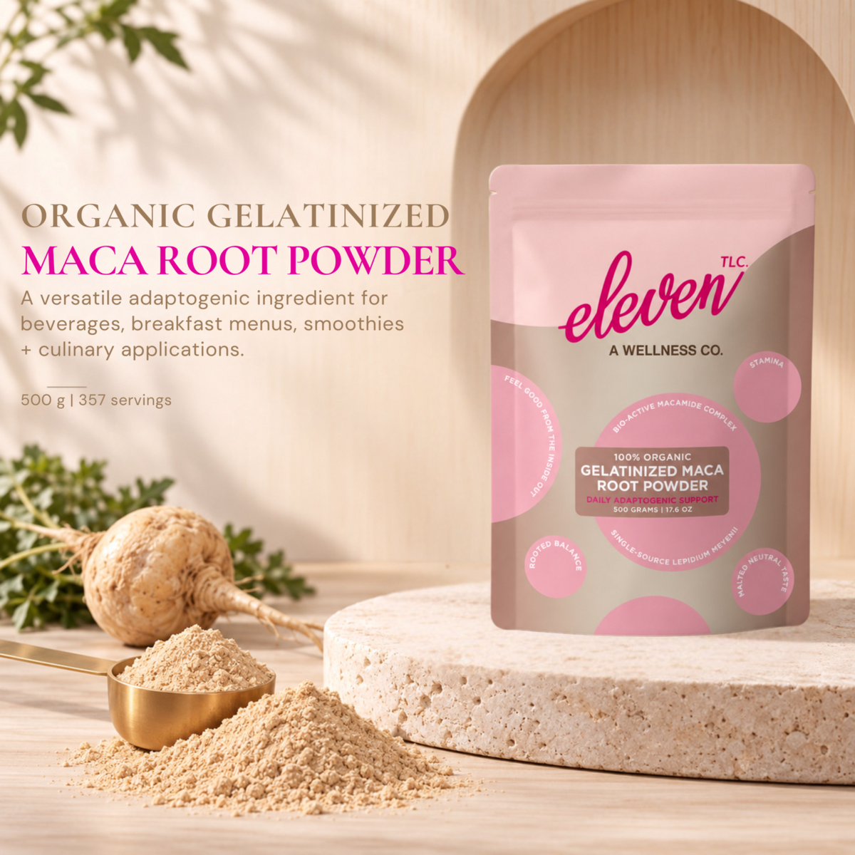 Eleven TLC Organic Gelatinized Maca Root Powder 500 g bag with maca root, powder and a gold measuring cup on warm stone.