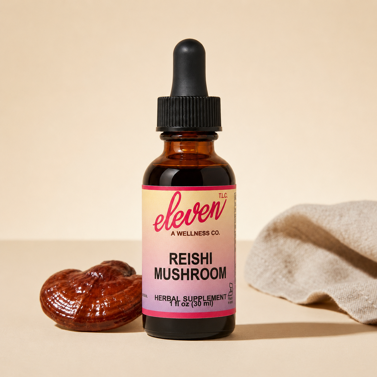 Eleven TLC reishi mushroom tincture bottle with dried reishi mushroom and linen cloth on a beige minimalist surface