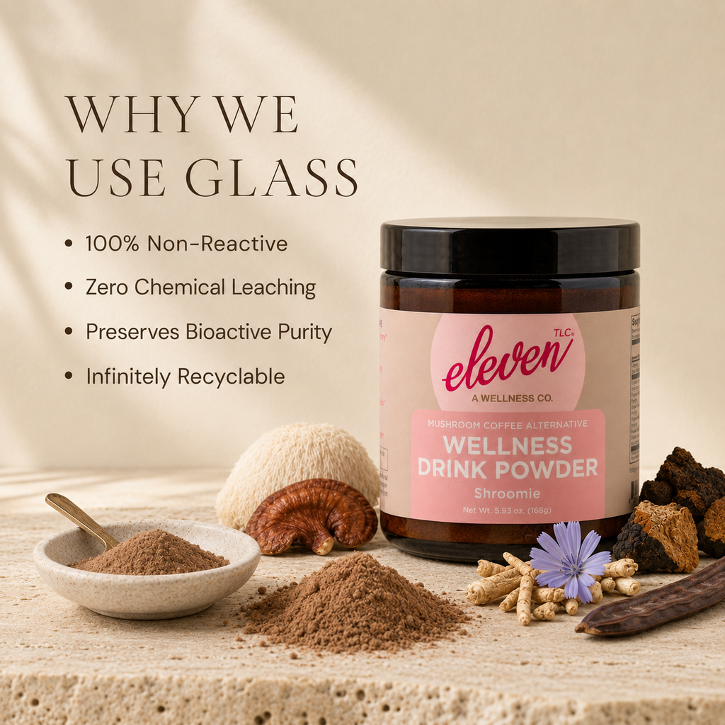 Eleven TLC Shroomie wellness drink powder in a non-reactive glass jar on a wooden surface with raw botanical ingredients.